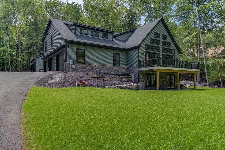 Custom home with stone and sage siding by Hilltop Builders